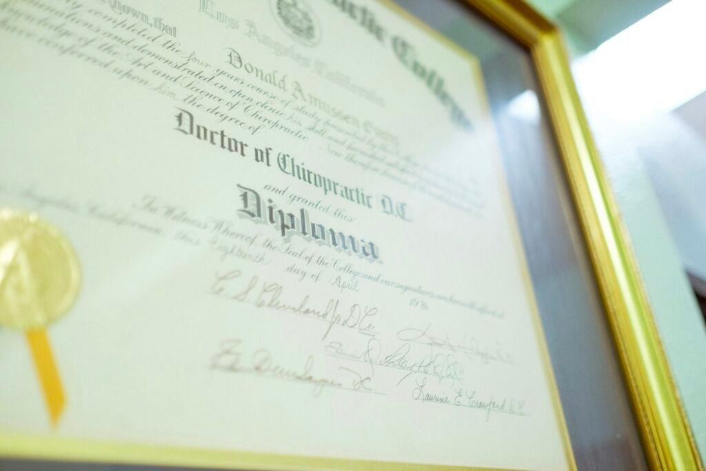 A framed diploma with a gold seal